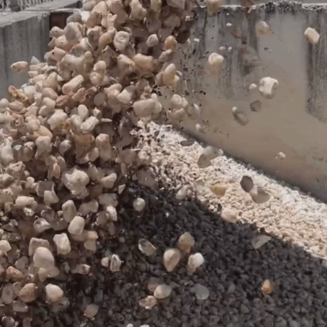 Load video: White garden pebbles available at Burrum Landscape Supplies in Howard by the bobcat scoop, per cubic metre or part there of.